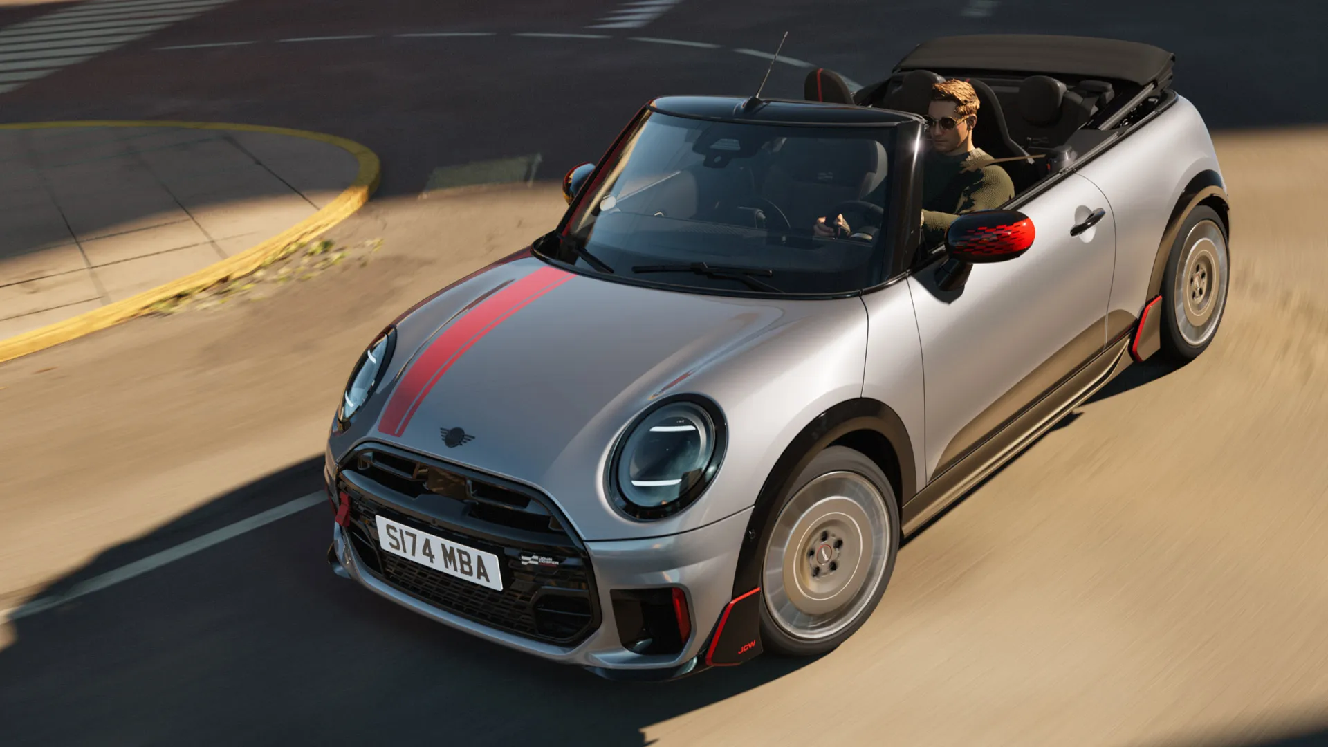 Yläkuva edestä MINI-avoauton urheilullisista John Cooper Works -tarroista Chili Red -sävyssä.